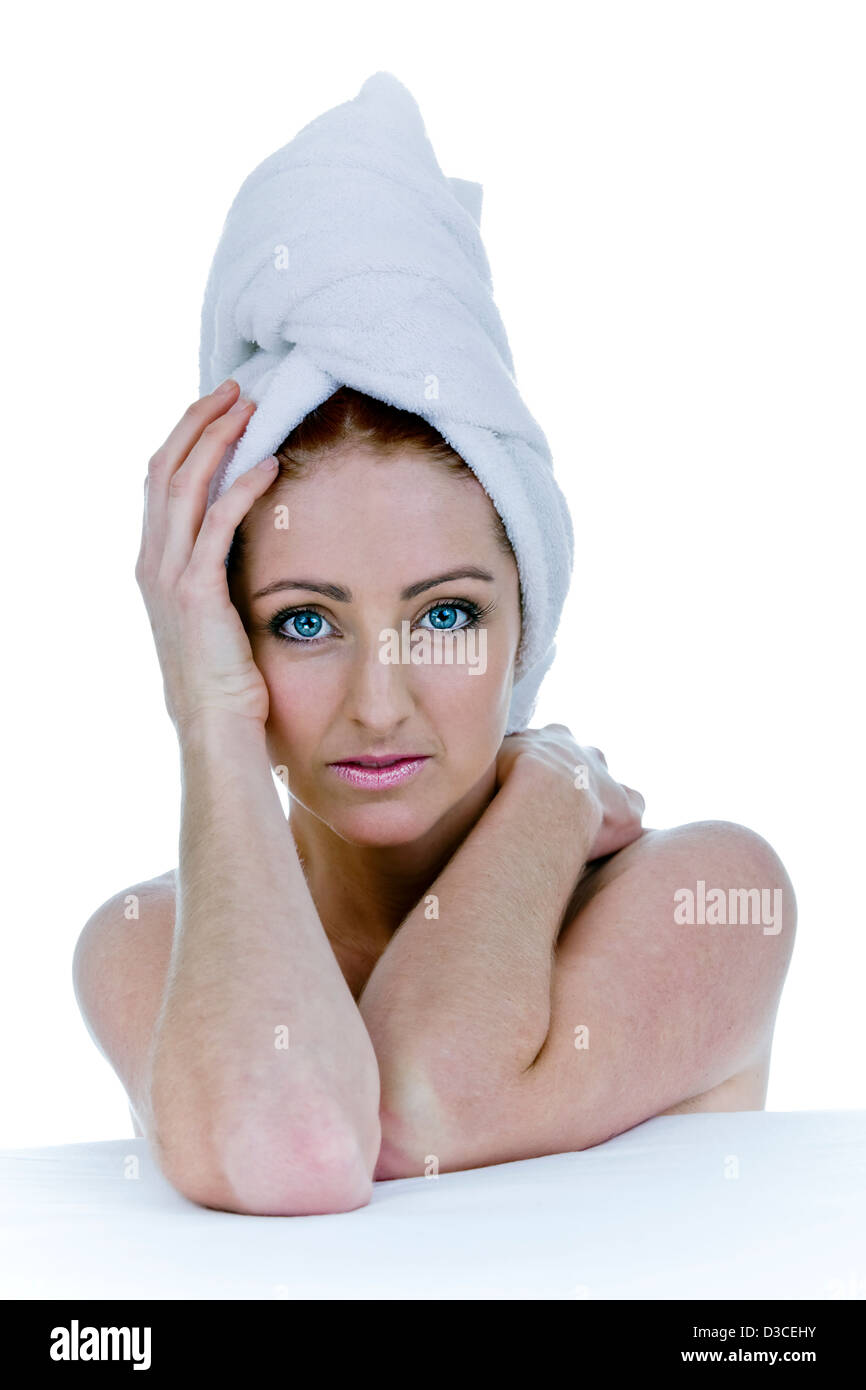 A naturally beautiful young woman fresh and clean after showering with a white towel wrapped around her head Stock Photo