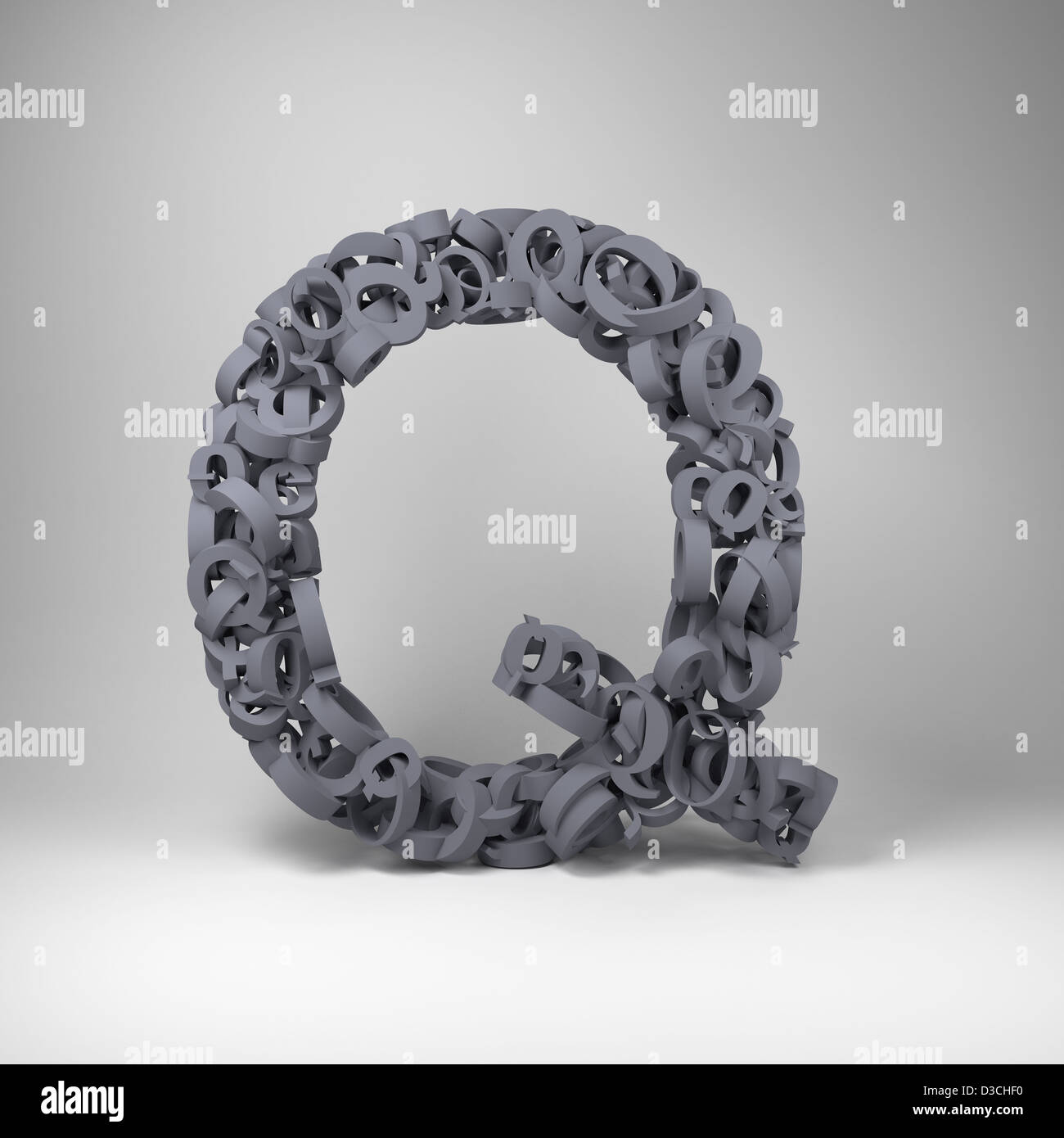 Letter Q made out of scrambled small letters in studio setting Stock Photo