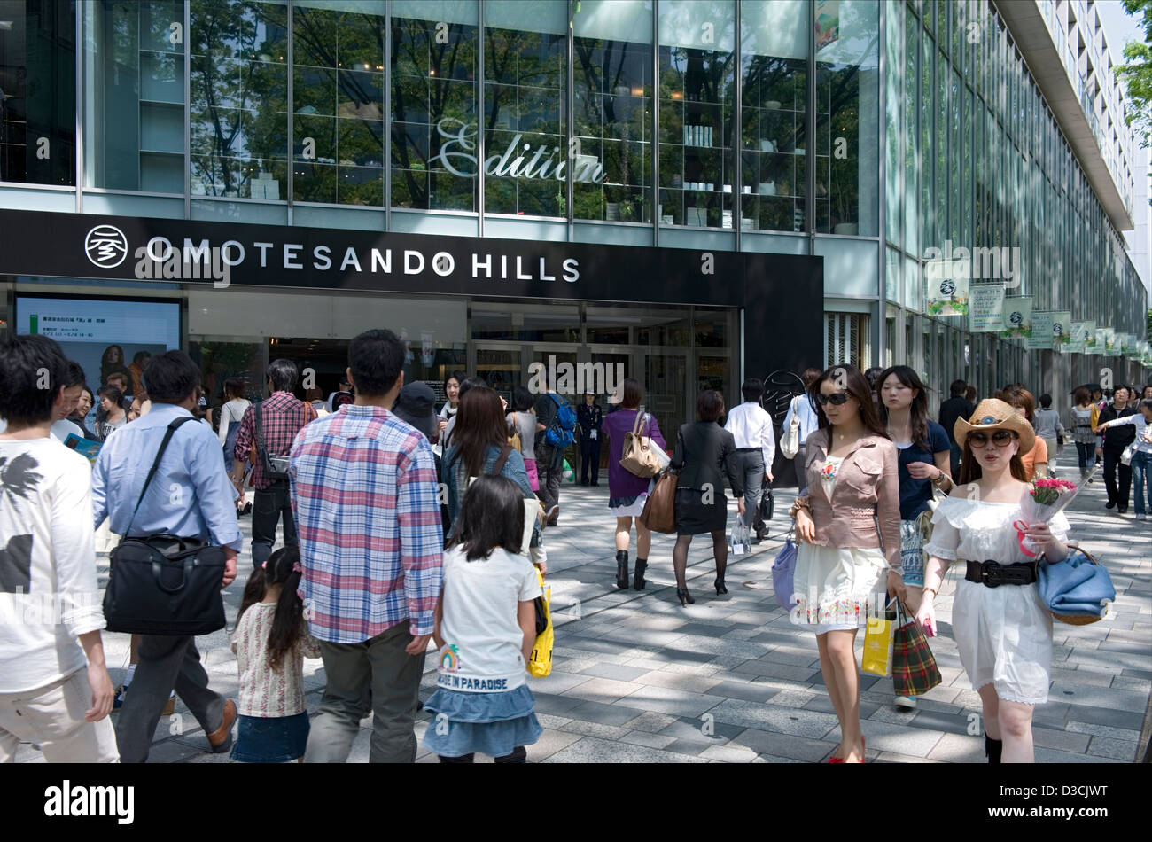 Shoppers strolling past Omotesando Hills shopping mall along Omotesando-dori Street in the upscale Shibuya ward of Tokyo, Japan. Stock Photo