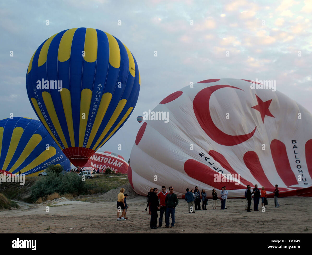 Hot air balloons being inflated to fly over Cappadocia (Kapadokya), Nevsehir Province, Turkey, listed as a World Heritage Site. Stock Photo