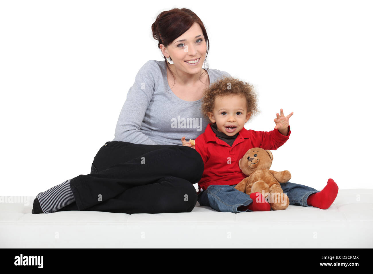 Mother sat with little boy and toy bear Stock Photo - Alamy