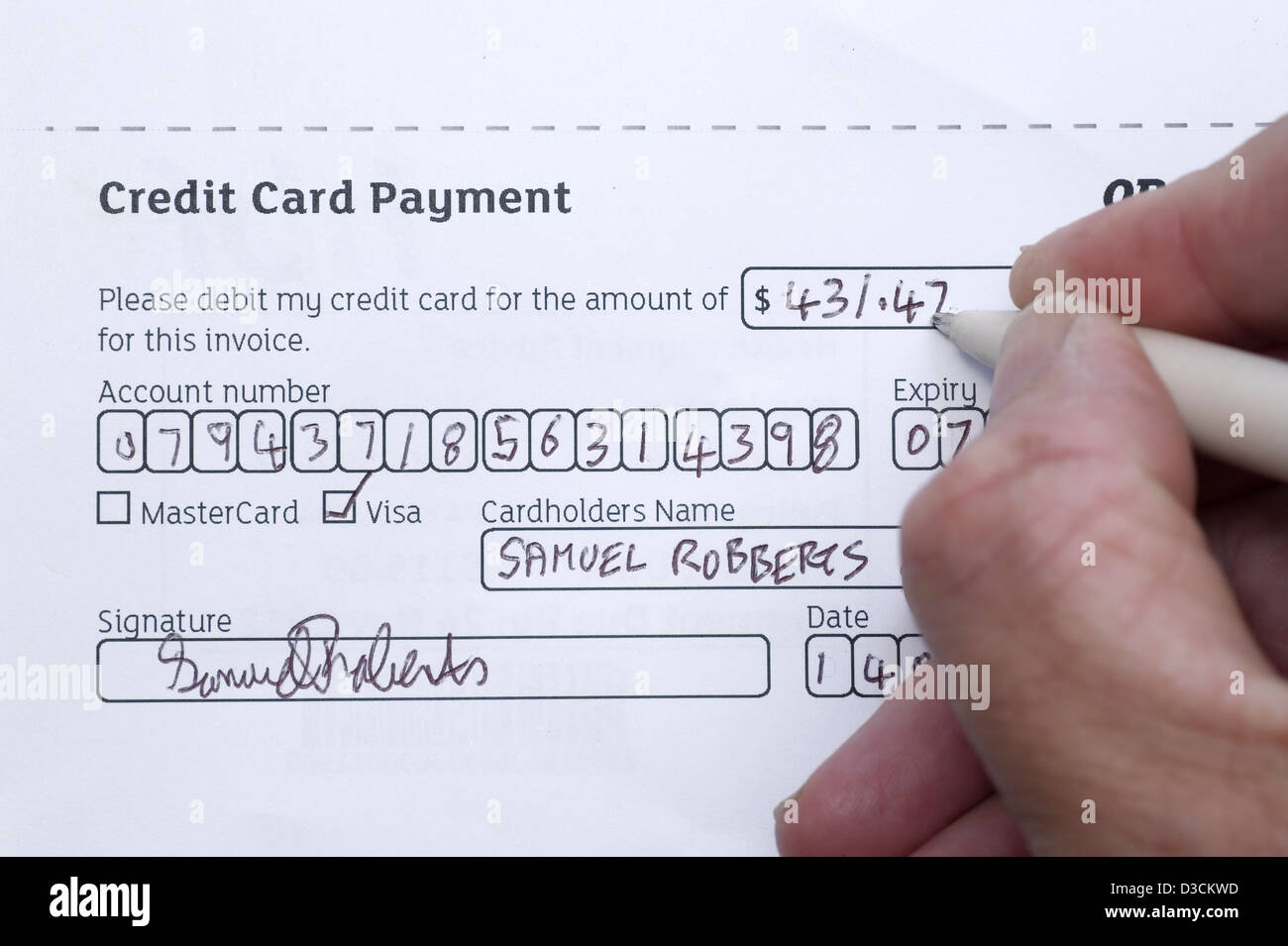 Filling in a form for credit card payment. Stock Photo