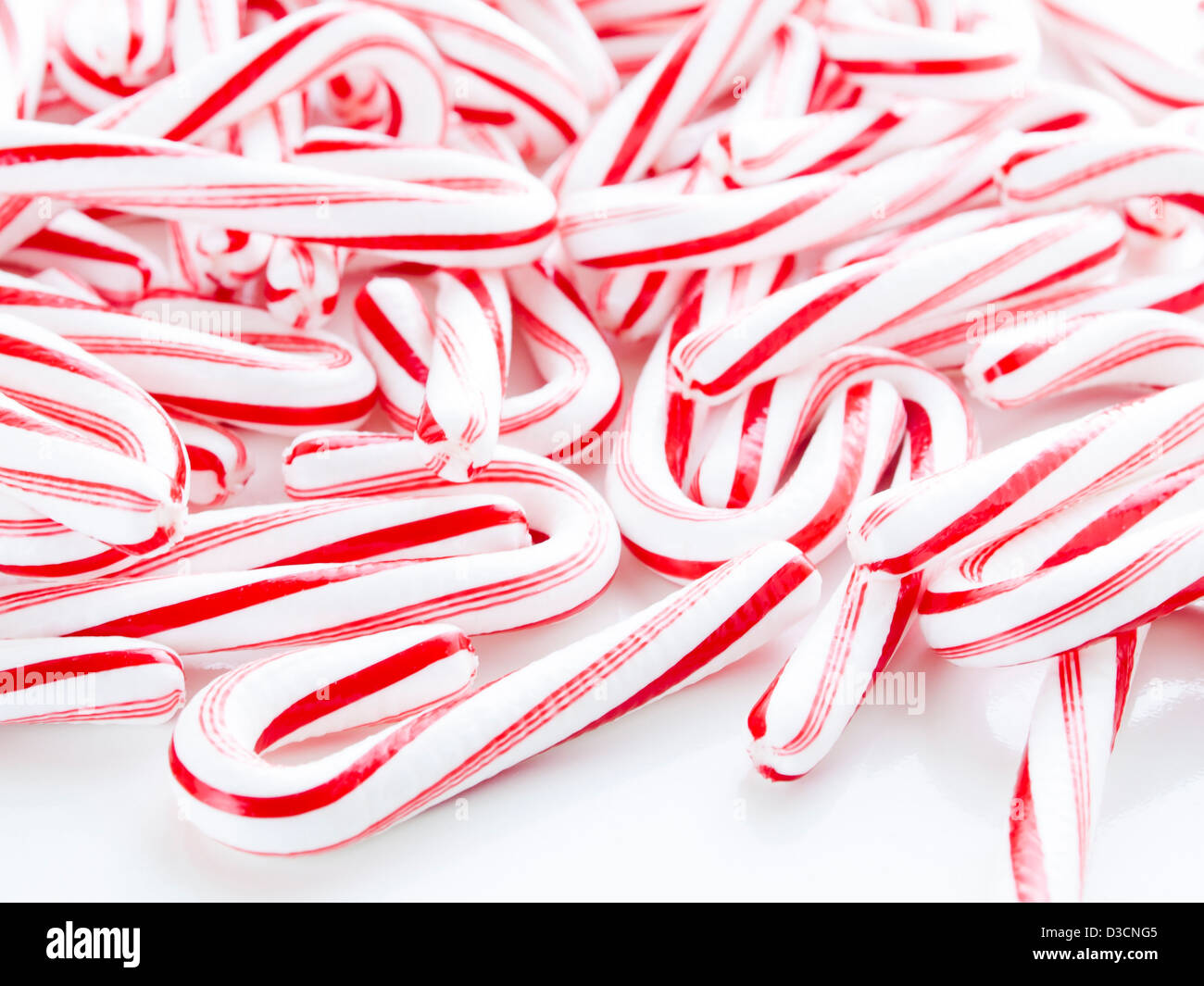 Peppermint candy canes on white background Stock Photo - Alamy