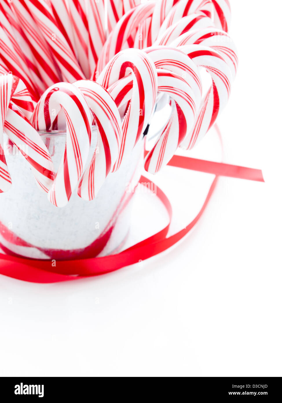 Peppermint candy canes in metal bucket on white background Stock Photo