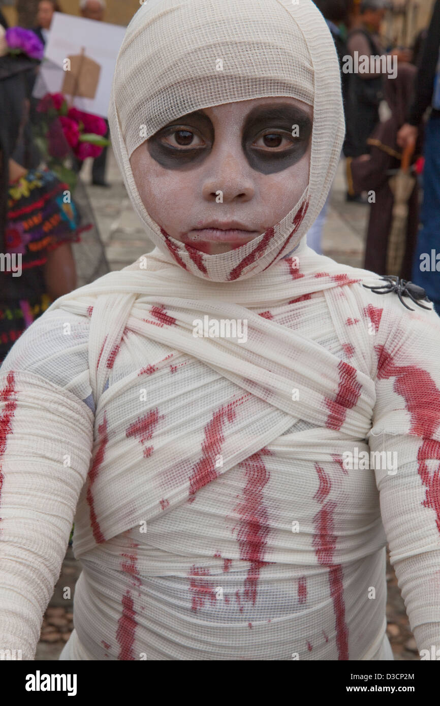 Boy wrapped bloody gauze as a mummy for Day of the Dead festivities, Oaxaca, Mexico. Stock Photo