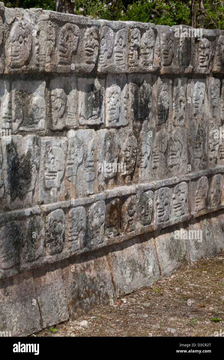 Detail of skull carvings on the wall of skulls (Tzompantli), Chichen Itza, Mexico Stock Photo