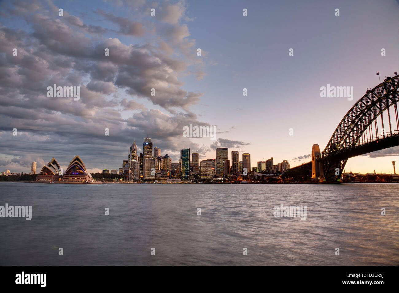 Sydney Opera House and Sydney Harbour Bridge looking back to the Sydney CBD at sunset Stock Photo