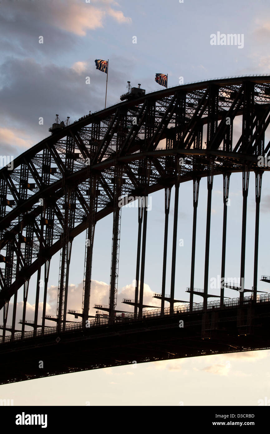 Australian Flags flying on the Sydney Harbour Bridge at sunset Sydney Australia Stock Photo
