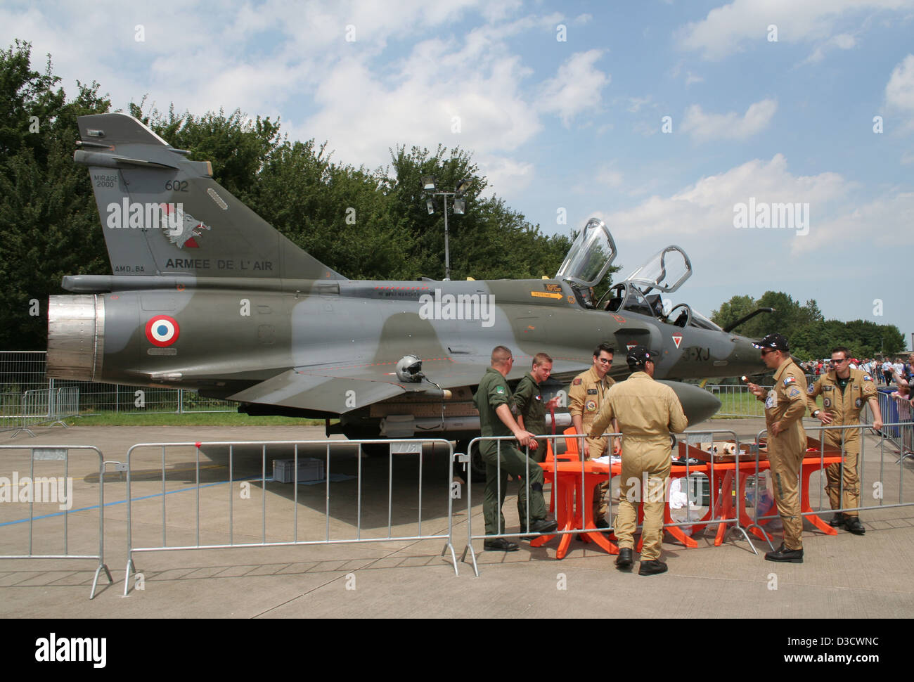 Air crew standing near a French Mirage 2000 fighter jet during an airshow. Stock Photo
