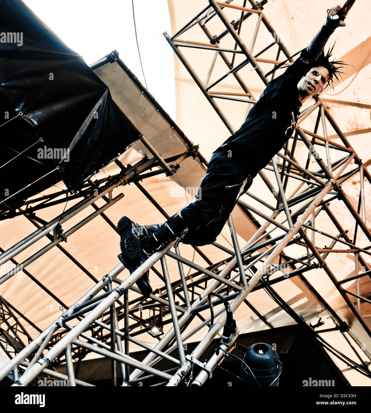 Rogue of the darkwave band The Crüxshadows climbing the stage rigging at the Amphi Festival in Cologne 2012 Stock Photo