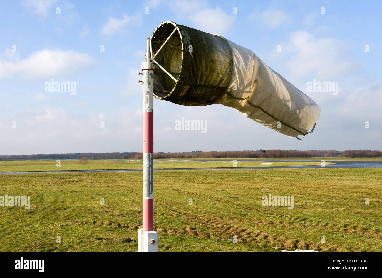 A dirty old windsock on a closed airfield but still working Stock Photo