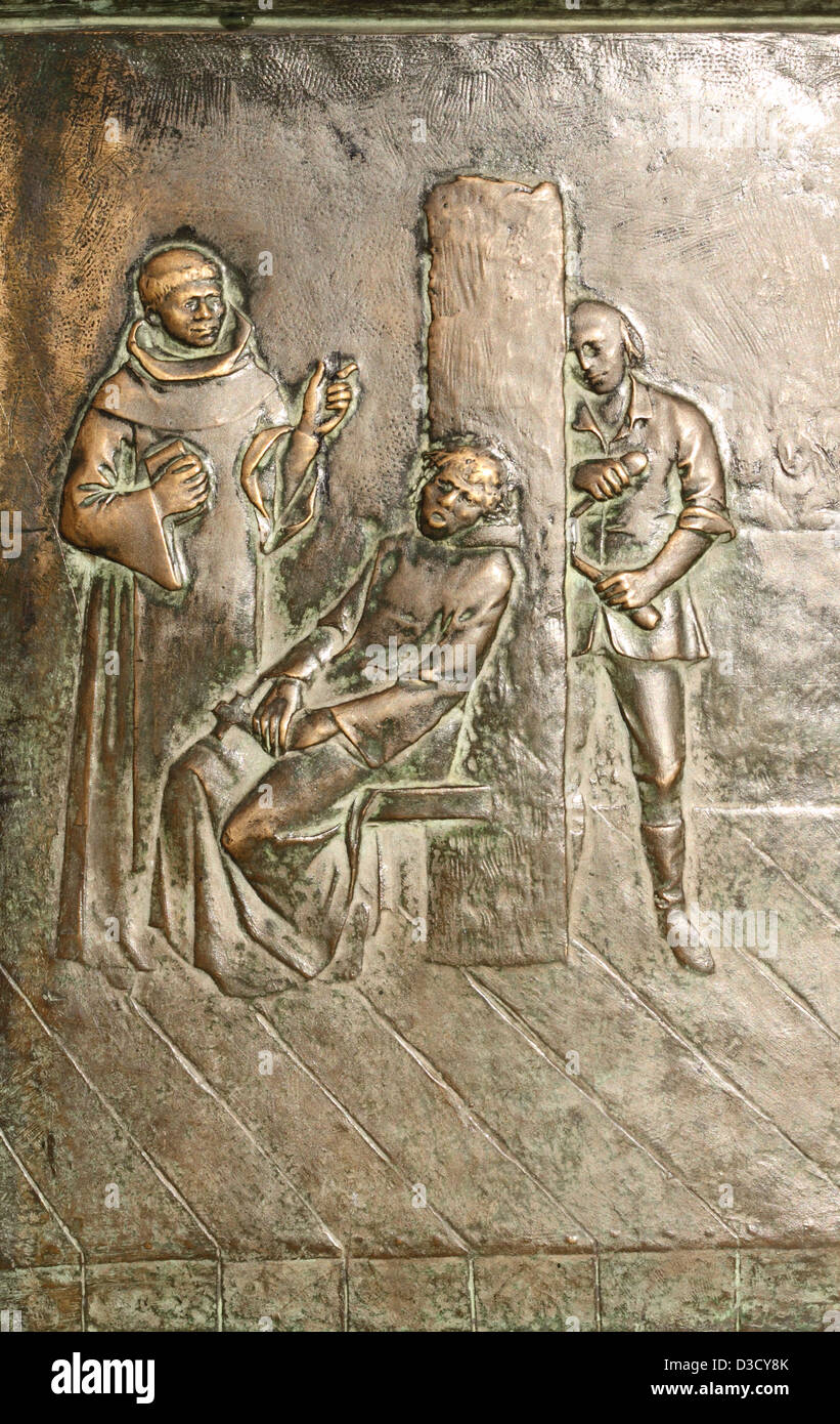 Madrid Spain detail on monument in Plaza Mayor showing public execution by garrotte during the Spanish Inquisition Stock Photo