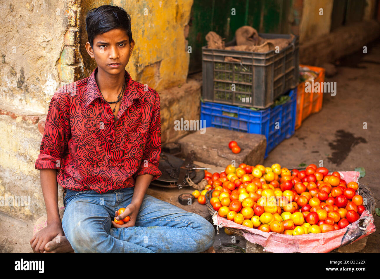 boy selling vegetables at a market, Varanasi, India Stock Photo