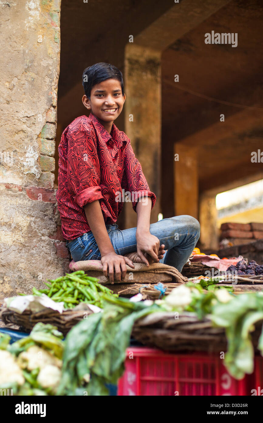 boy selling vegetables at a market, Varanasi, India Stock Photo