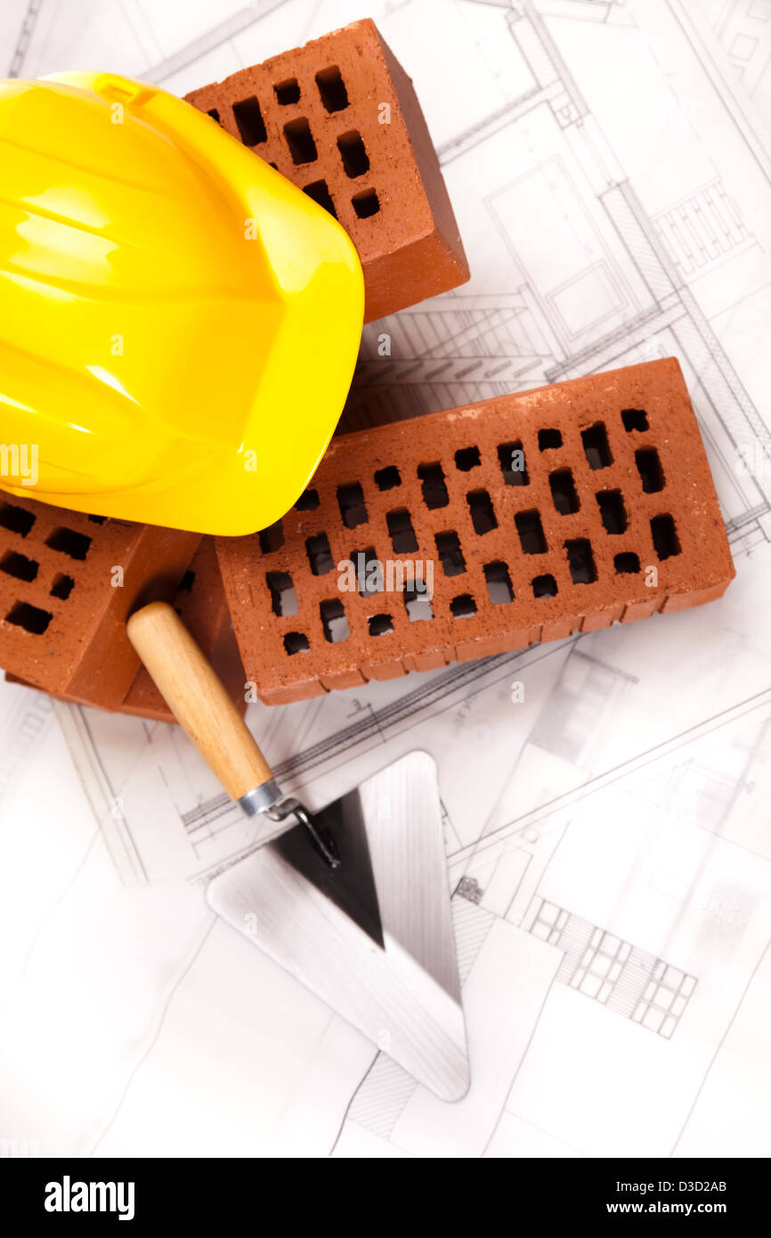 Bricks, trowel tool and Construction plans Stock Photo Alamy
