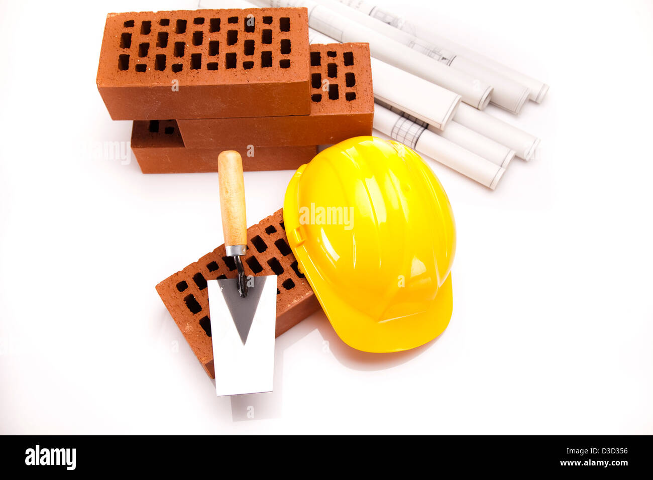 Bricks, trowel tool and Construction plans Stock Photo Alamy