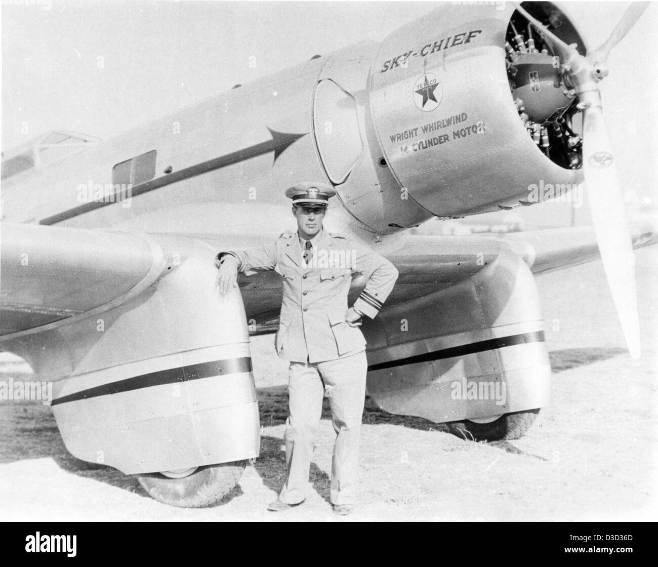 This photo from the Charles M. Daniels Collection features Frank Hawks standing in front of the Northrop Gamma 2A aircraft, Texaco No. 11 Sky Chief. Frank Hawks was an American aviator known for his cross-country flying feats in the 1930s, and the Gamma 2A was notable for its racing and commercial aviation roles. Stock Photo