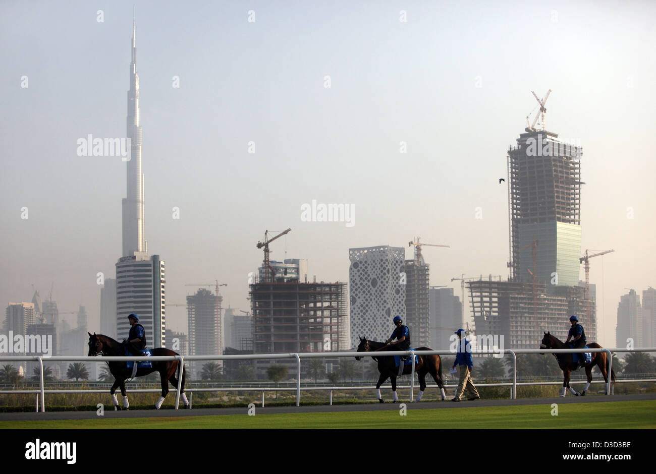 Dubai, United Arab Emirates, horses and riders against the skyline with the Burj Khalifa Stock Photo