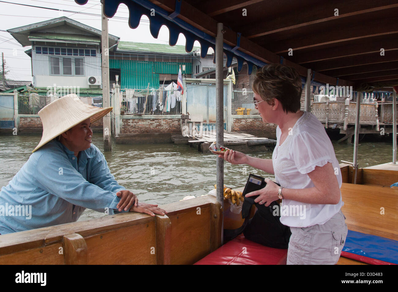 A river merchant selling fruit and vegetables to river users on The Chao Phraya river bangkok Stock Photo