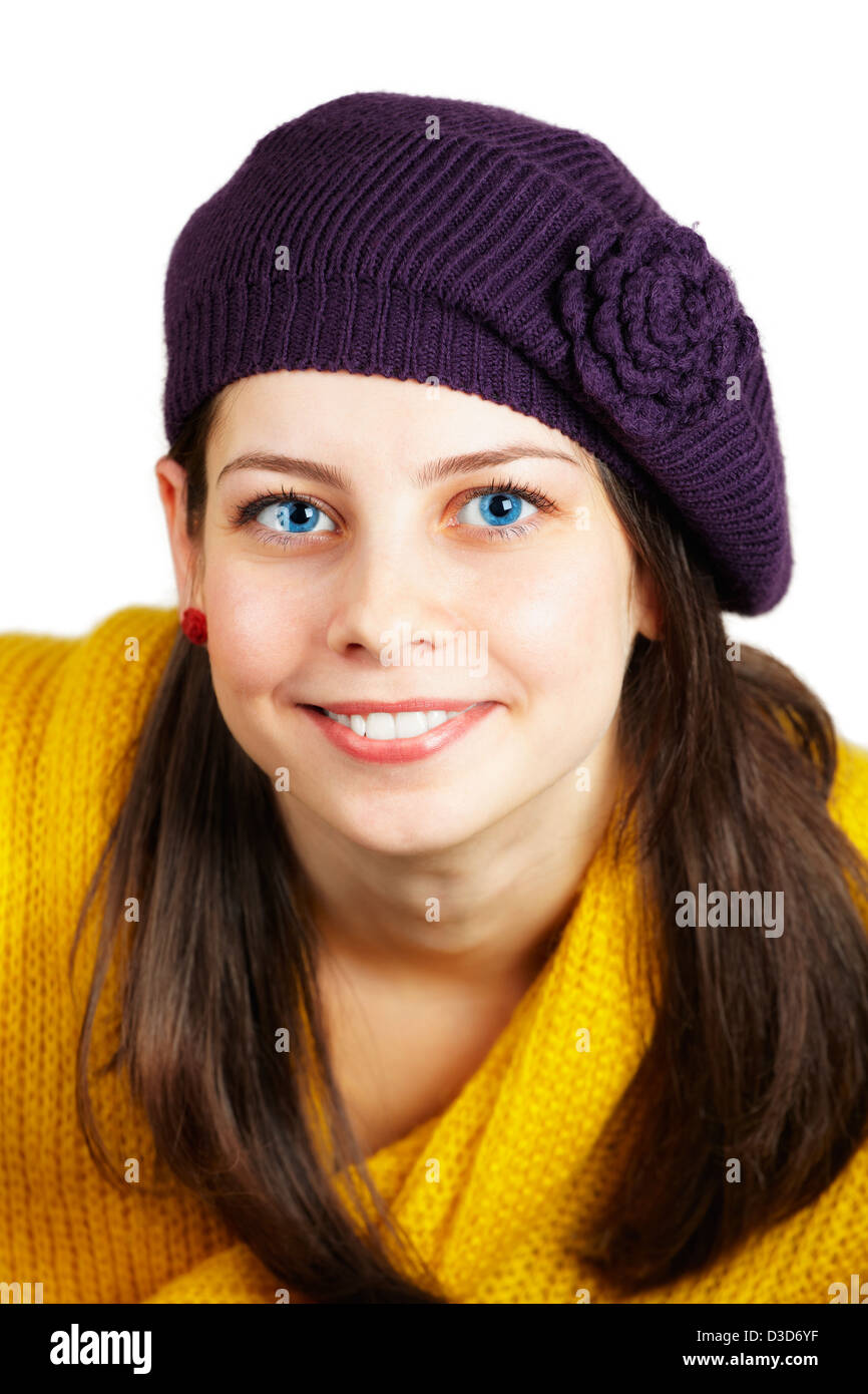 Portrait of a beautiful teenage girl with yellow scarf and purple hat ...