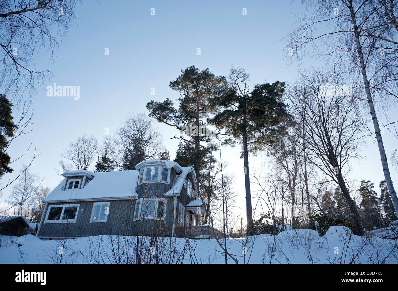 Dill, Sweden, wooden house in the snowbound village Trolldalen Stock Photo