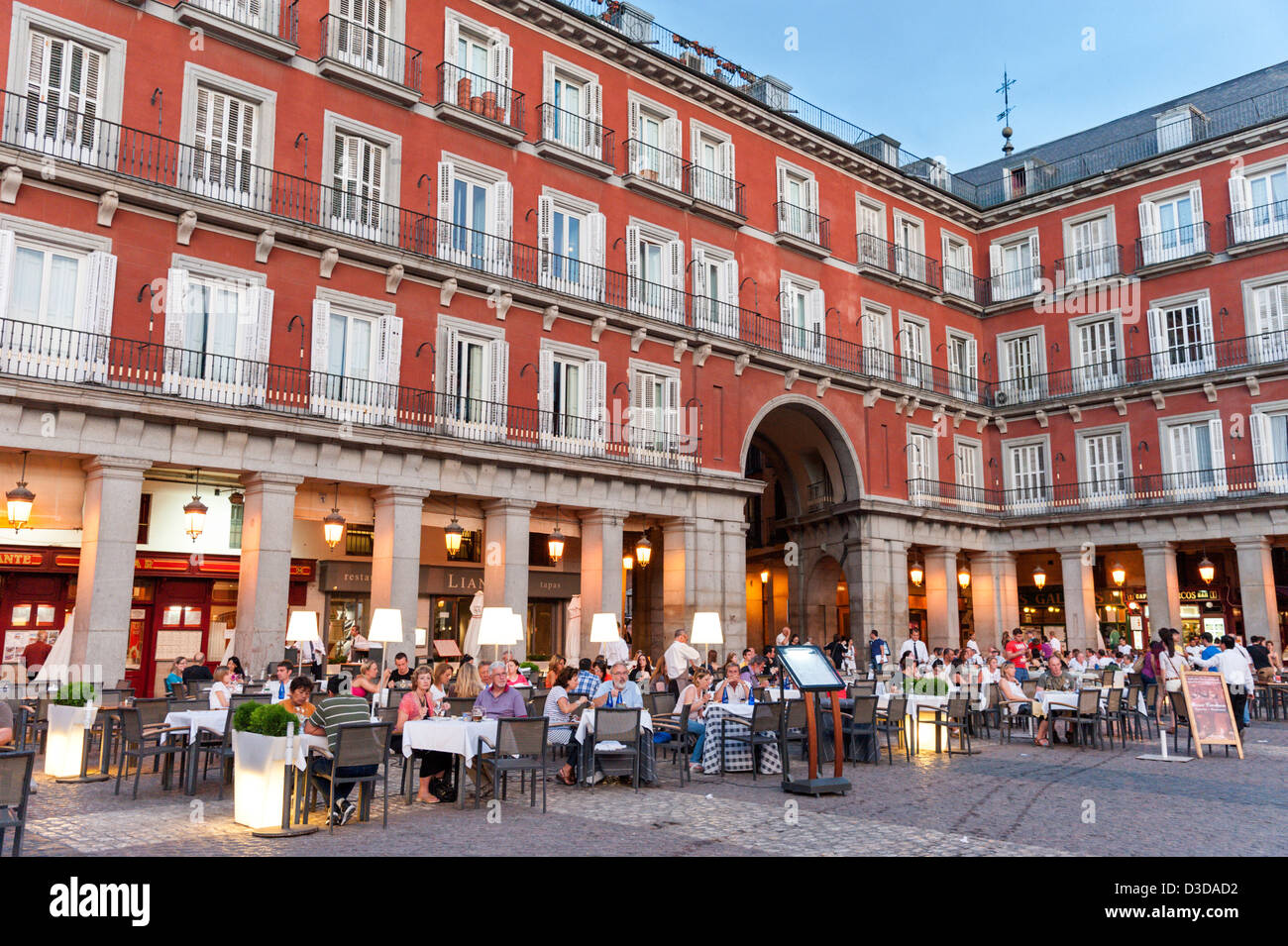 Early evening dining at one of the restaurants in the Plaza Mayor, Madrid, Spain Stock Photo