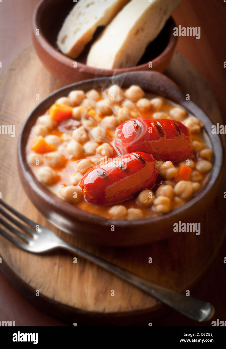 calorie tasty dish of chickpeas with roasted sausages Stock Photo