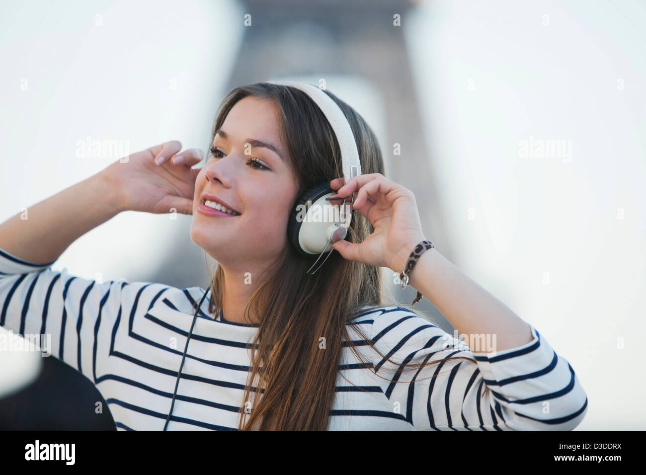 Woman listening to music on headphones Stock Photo