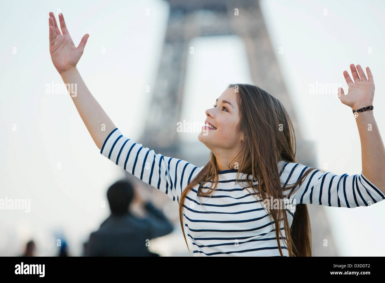 Woman looking excited with her arms raised Stock Photo