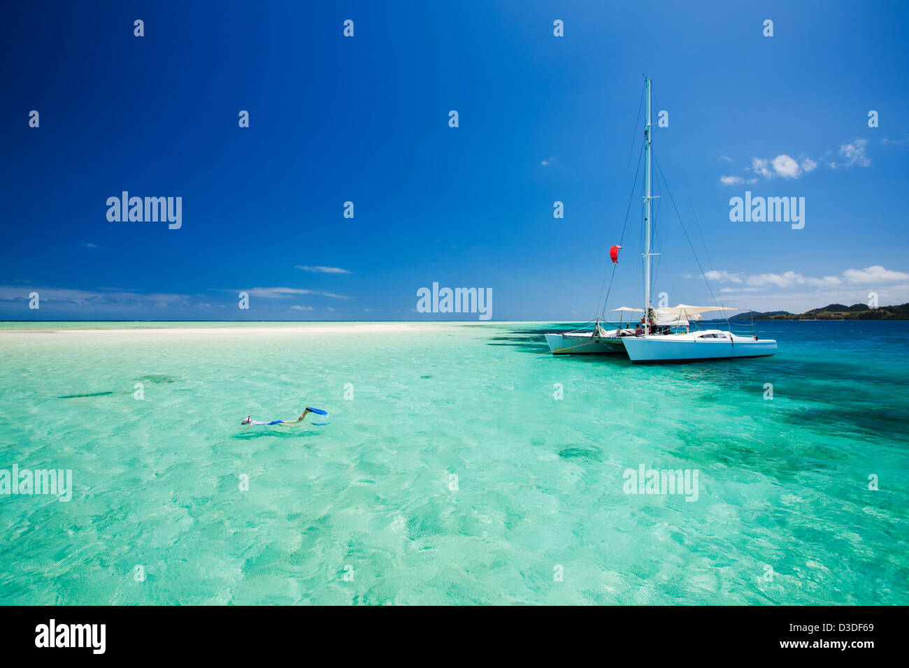 Snorkeling in shallow tropical water off the catamaran Stock Photo