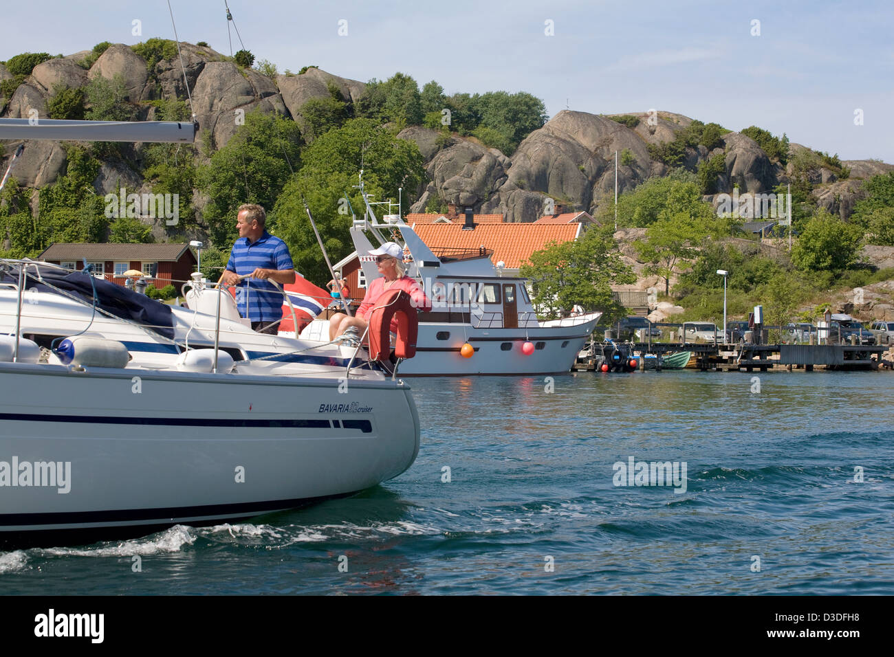 Hamburgsund, Sweden, landscape with sailboat and Sommerhaeusern Stock Photo