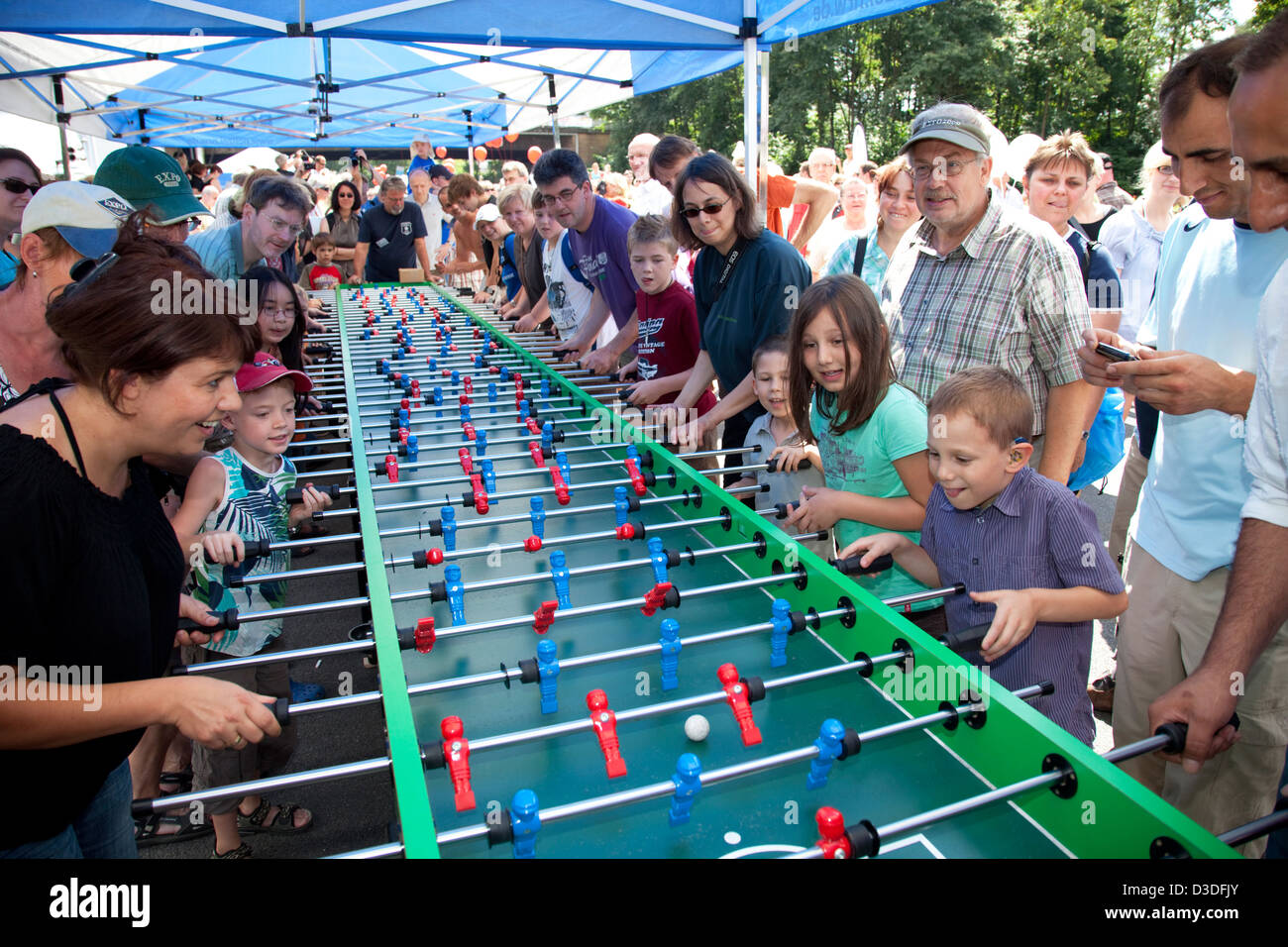 Bochum, Germany, people are playing on a giant foosball table on the Still Life Ruhr Stock Photo