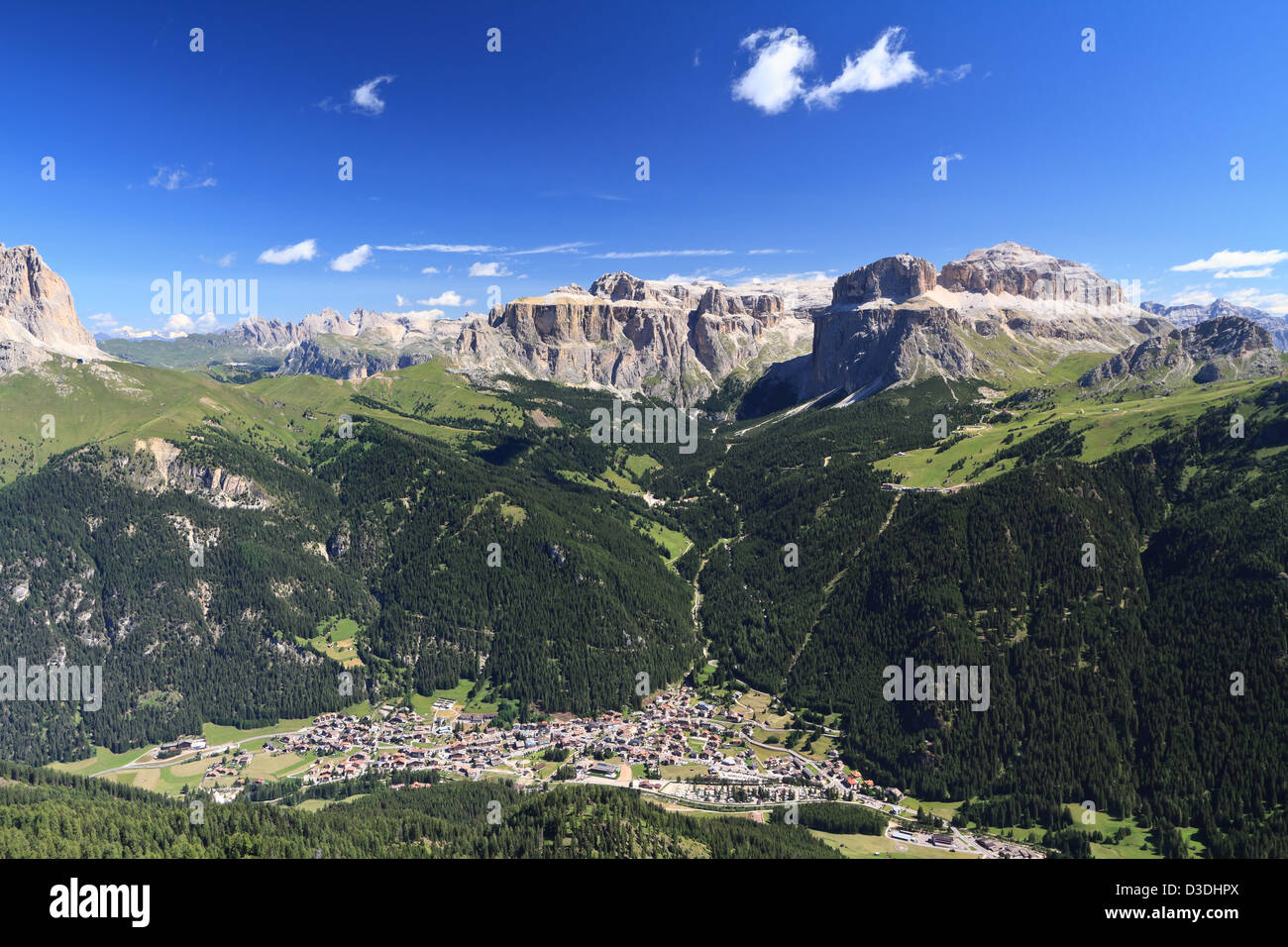 Aerial view of Canazei and Fassa valley with Saas Pordoi mount, Sella and Pordoi pass and Sassolungo mount Stock Photo