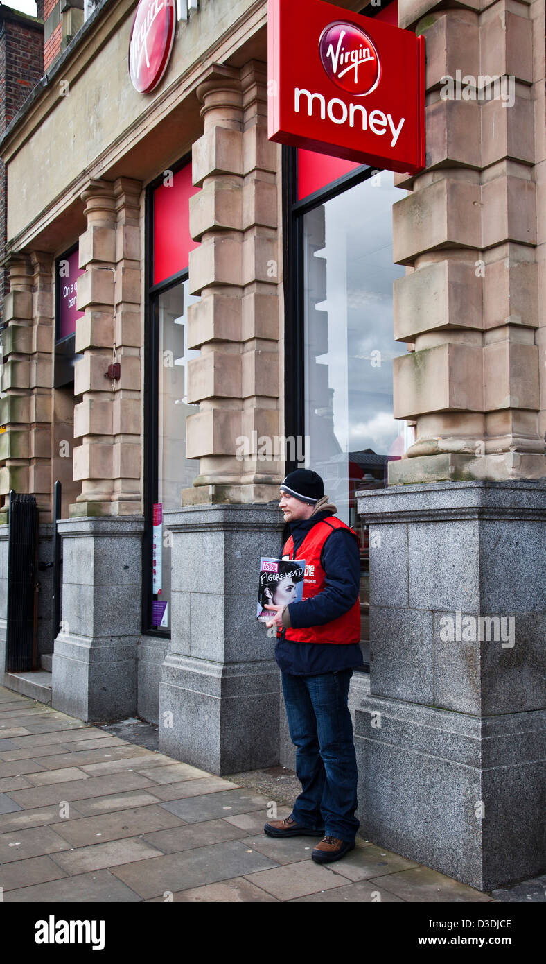 Big issue selling Figurehead magazine, outside Virgin Money Bank, in