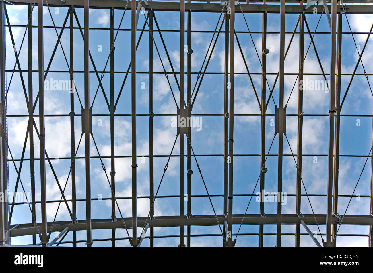 Blue sky with white clouds viewed by a metal ceiling construction Stock Photo