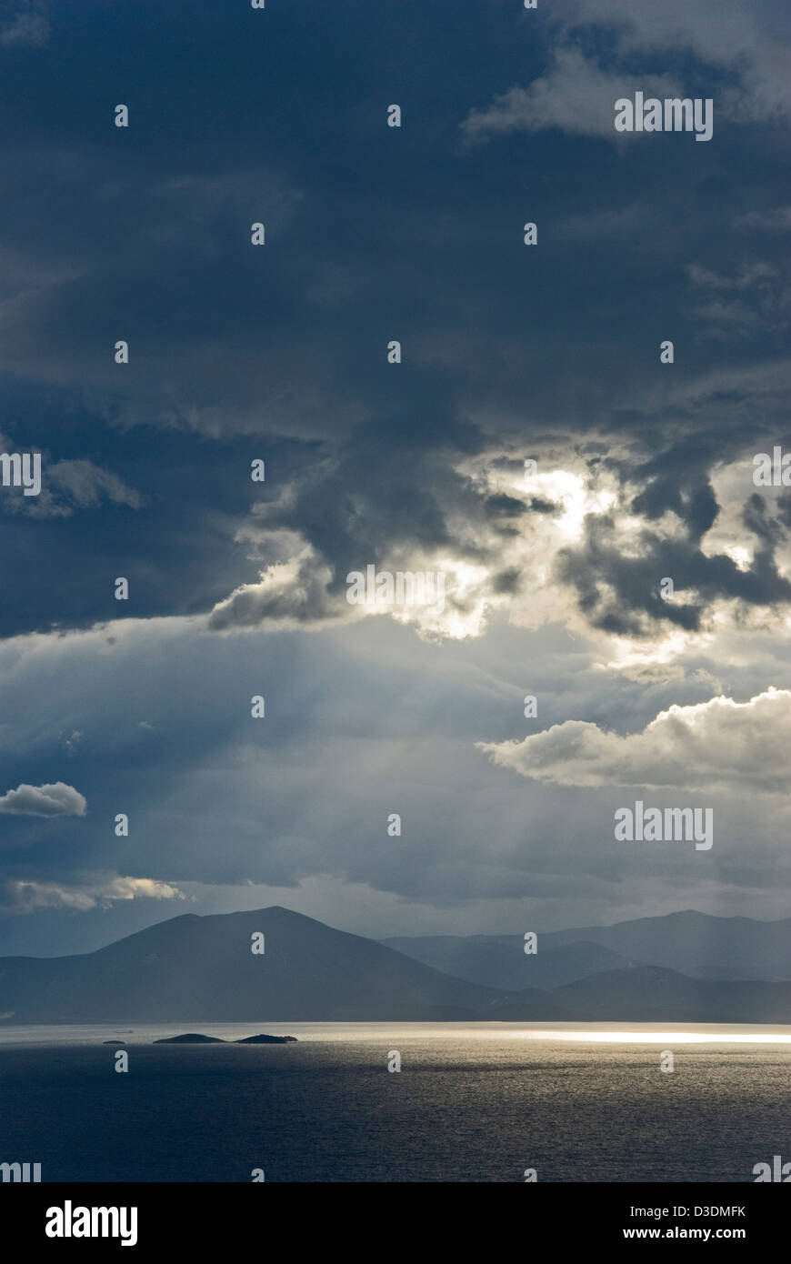 Dramatic sky above sea and mountains Stock Photo