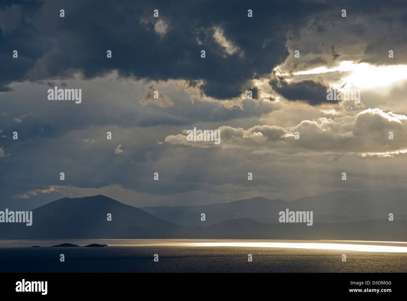 Dramatic sky above sea and mountains Stock Photo