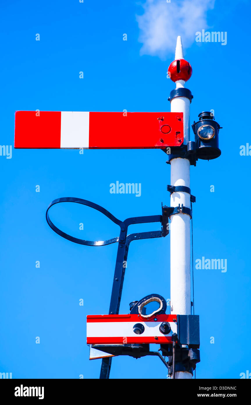 Red 'Stop' railway signal against blue sky Stock Photo