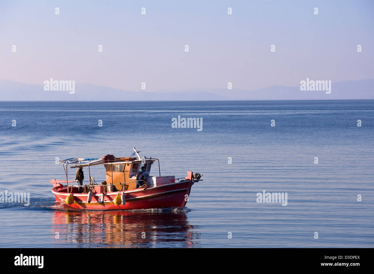 Fishing boat returns into port Stock Photo