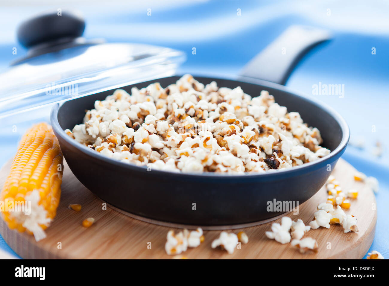 Popcorn cooked in a frying pan and ear of maize, closeup Stock Photo