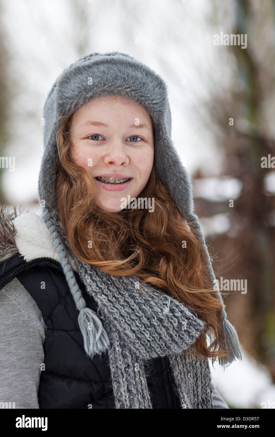 Outdoor portrait of a cheerful teenager girl in winter cloths Stock Photo