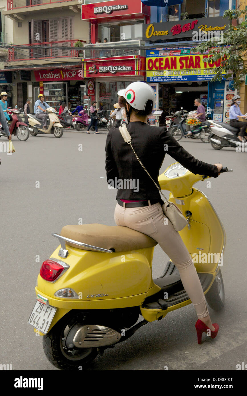 Backview of a woman in a motor bike Hanoi, Vietnam Stock Photo
