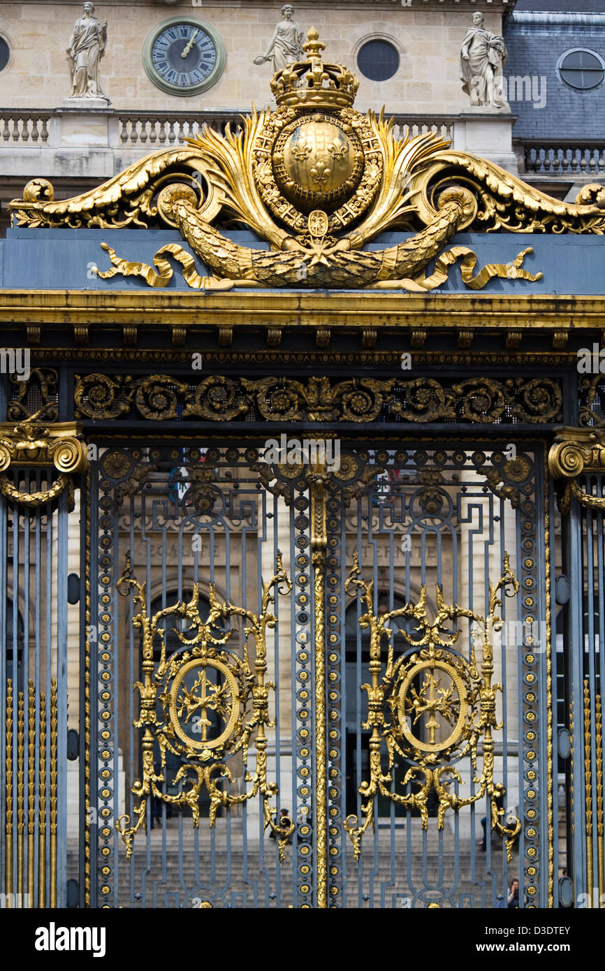 Partial view of a beautiful golden gate on a building in Paris, France