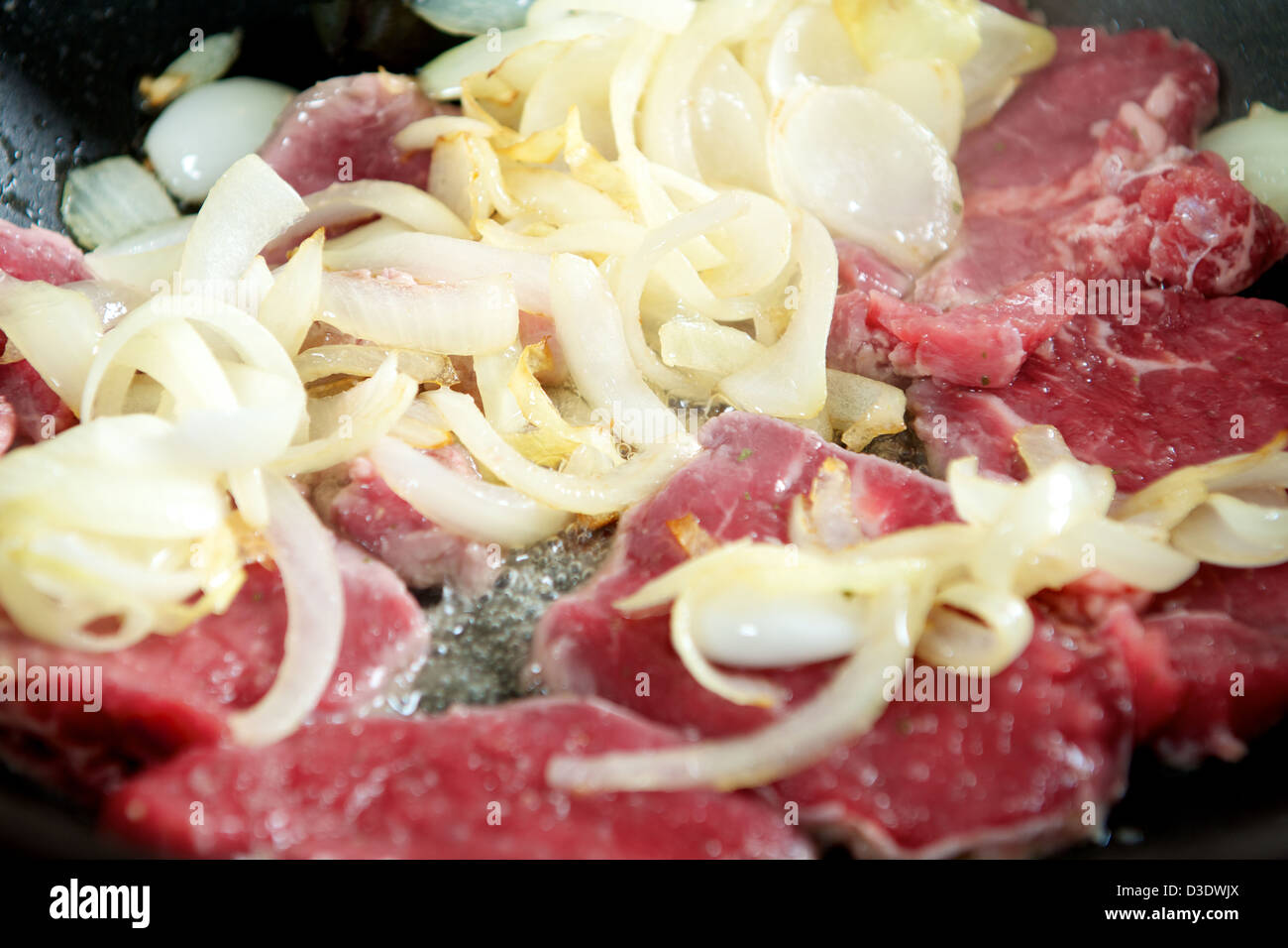 Stir frying onion beef in a wok Stock Photo Alamy