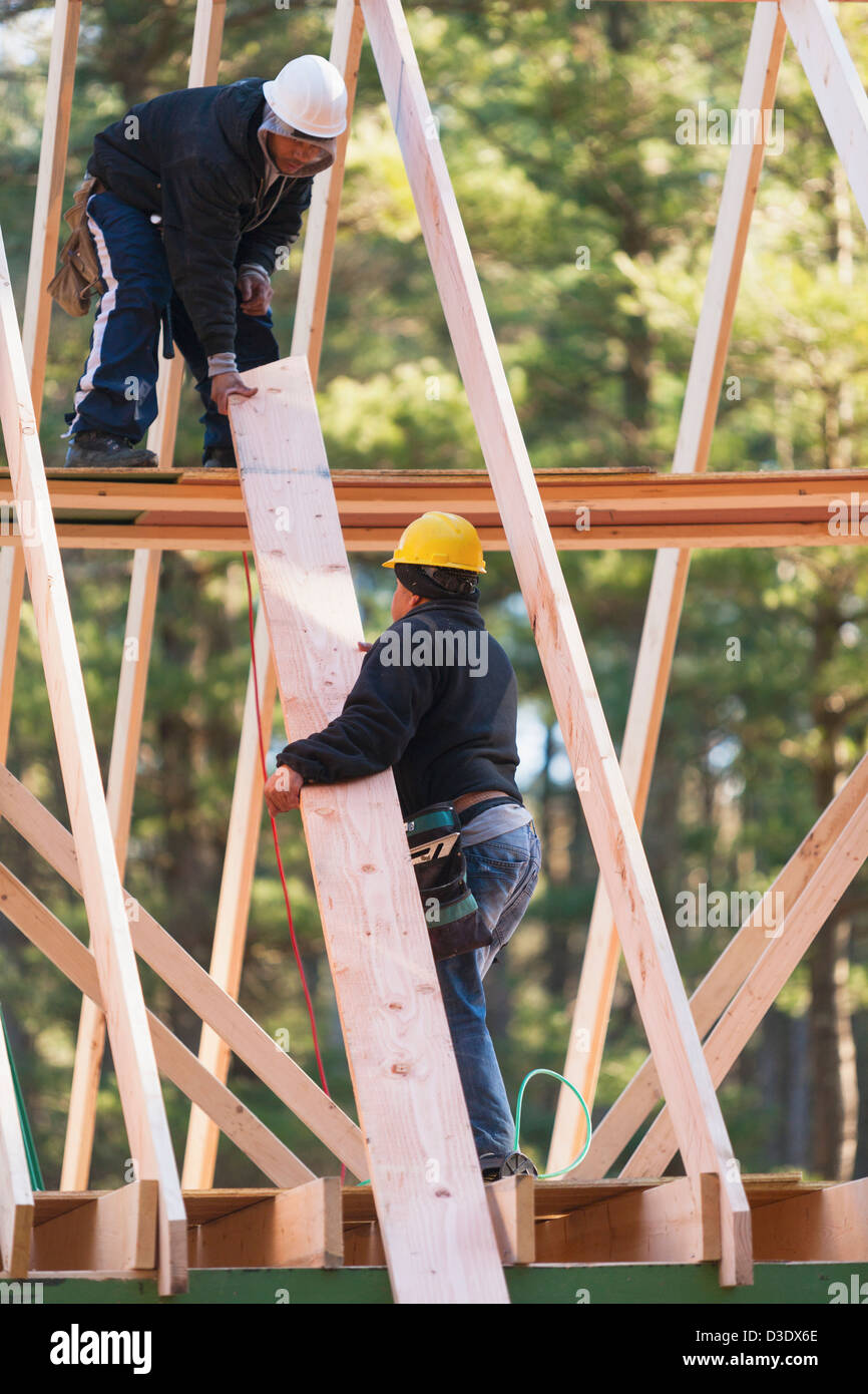 Carpenters moving rafter into place Stock Photo Alamy