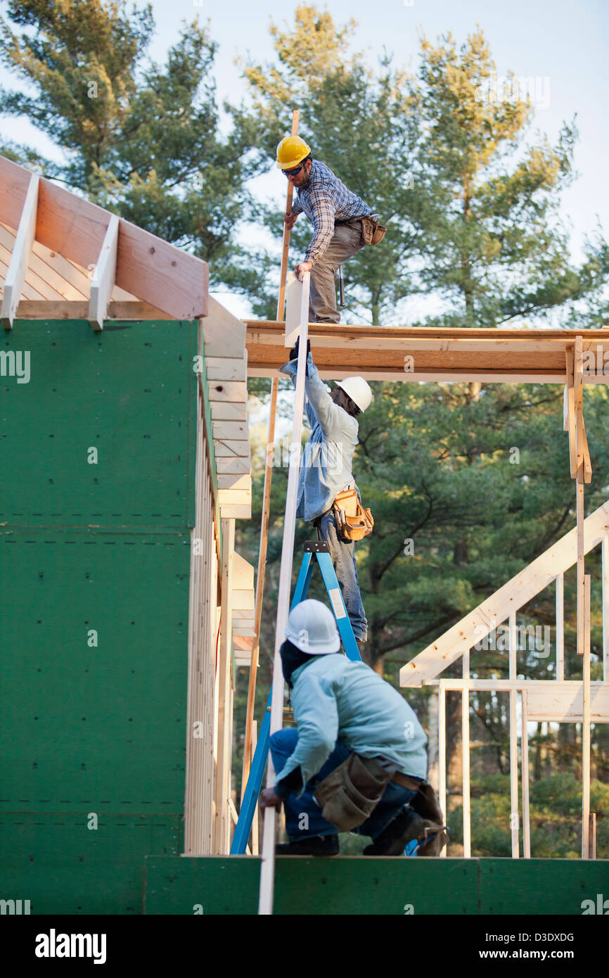 Carpenters placing a rafter Stock Photo - Alamy