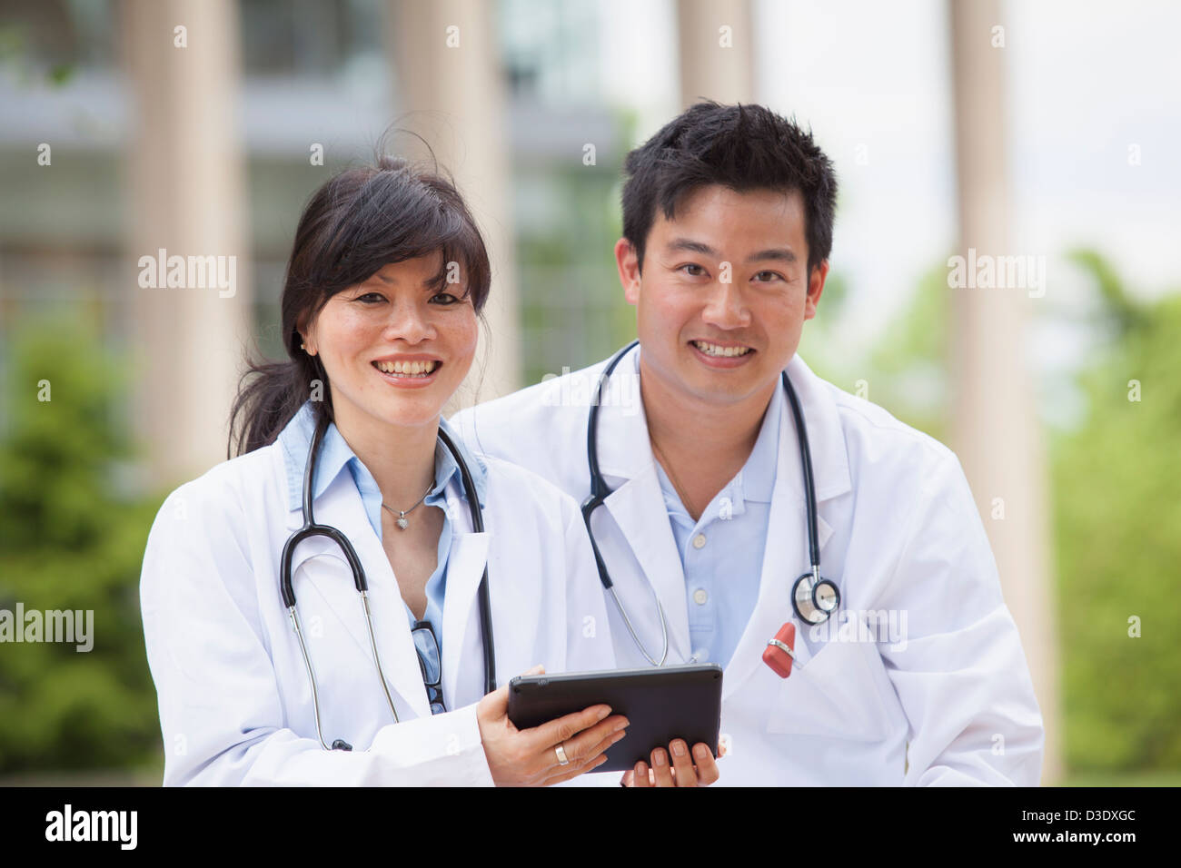 Doctors using a digital tablet Stock Photo