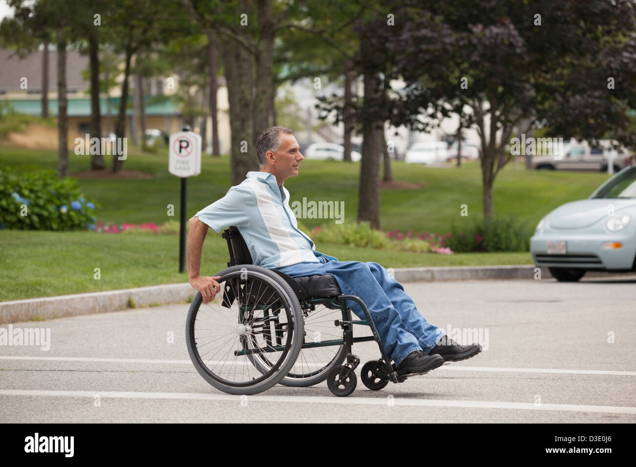 Man with spinal cord injury in a wheelchair crossing at accessible