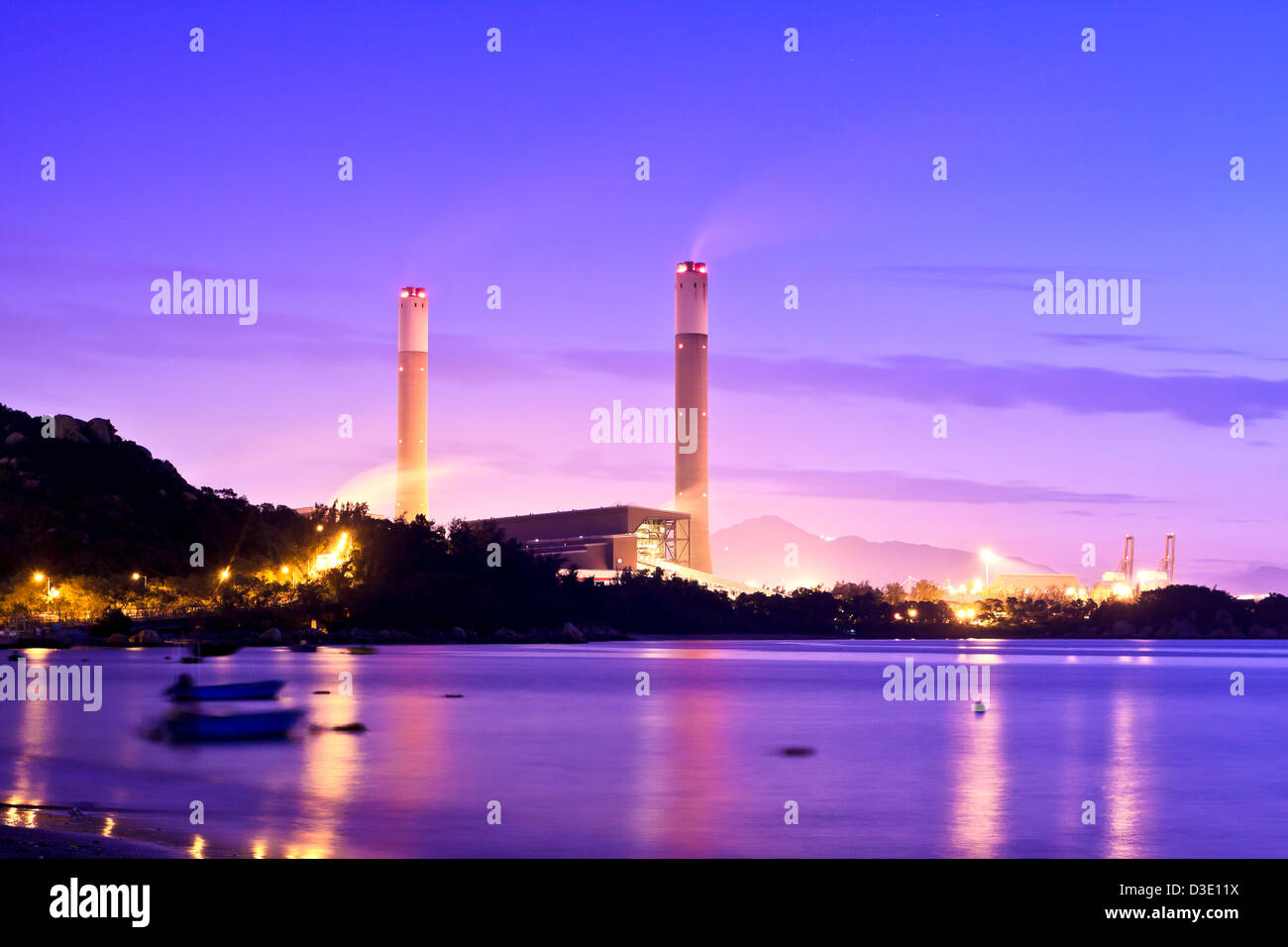 Power plant along coast at sunset Stock Photo