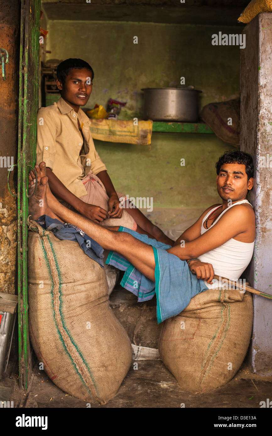 Indian men sitting inside a shop, Varanasi, India Stock Photo